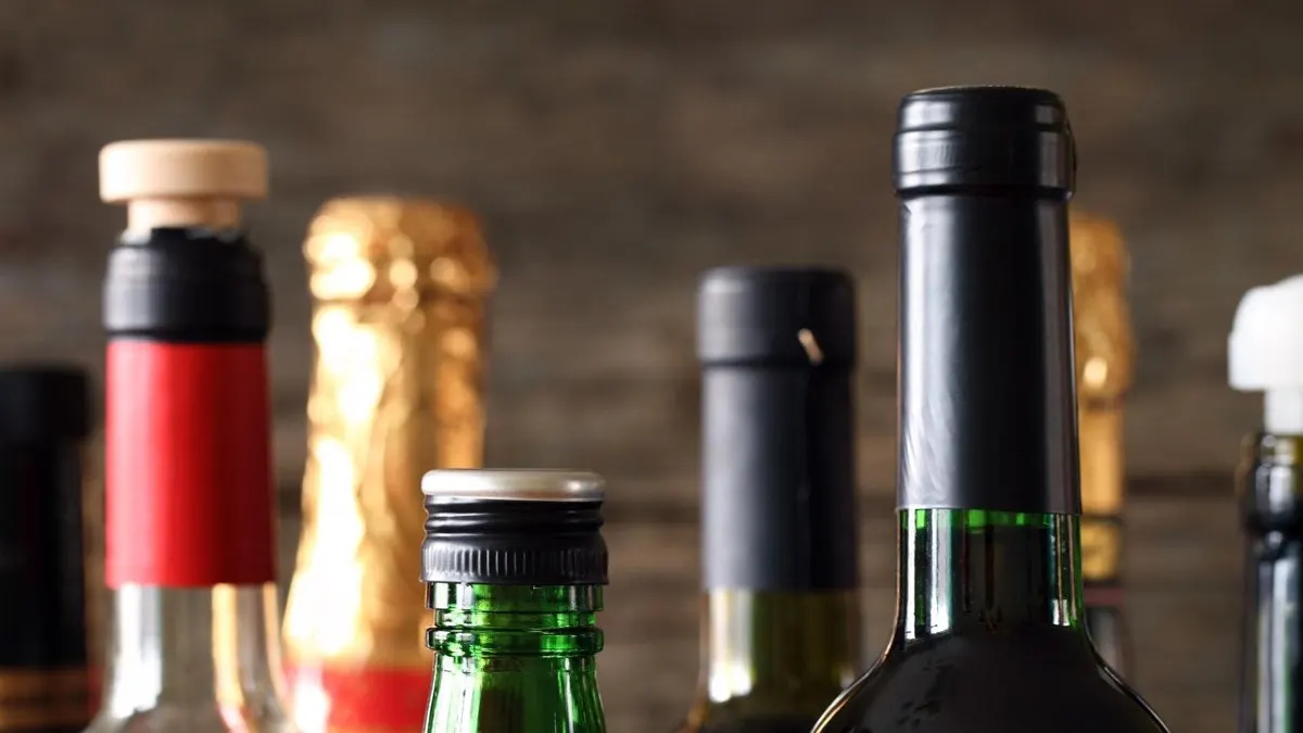 Row of wine and liquor bottles with different alcohol strengths